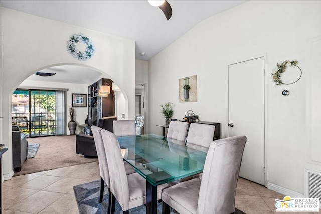 dining area featuring lofted ceiling, ceiling fan, and light tile patterned flooring