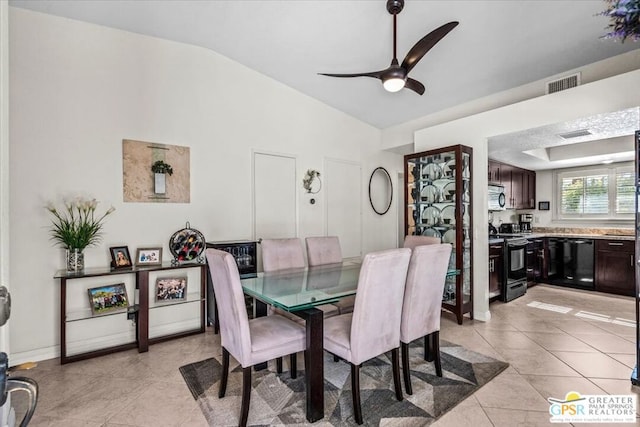 dining area featuring light tile patterned floors, vaulted ceiling, and ceiling fan