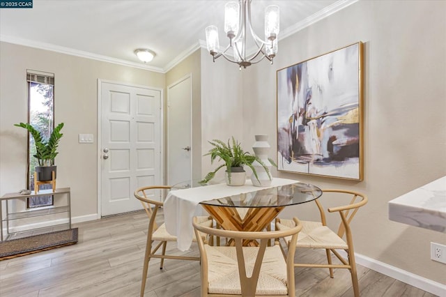 dining area featuring ornamental molding, an inviting chandelier, and light wood-type flooring