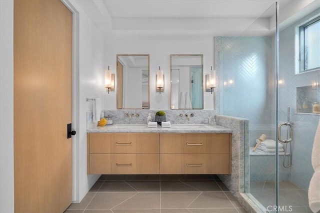 bathroom with tasteful backsplash, vanity, tile patterned floors, and a shower with shower door