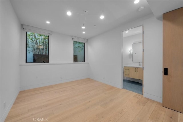 spare room featuring light hardwood / wood-style floors