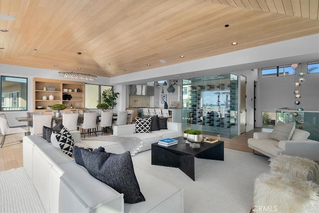 living room featuring a healthy amount of sunlight, wooden ceiling, light wood-type flooring, and a tray ceiling