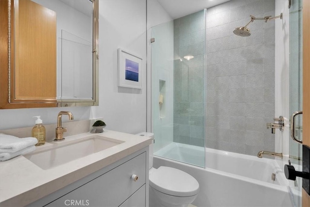 full bathroom featuring bath / shower combo with glass door, vanity, and toilet