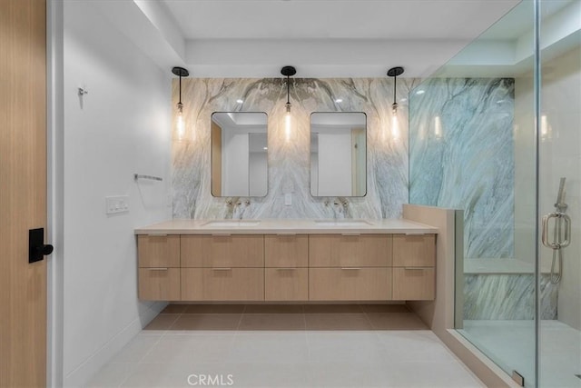 bathroom with an enclosed shower, vanity, and tile patterned floors