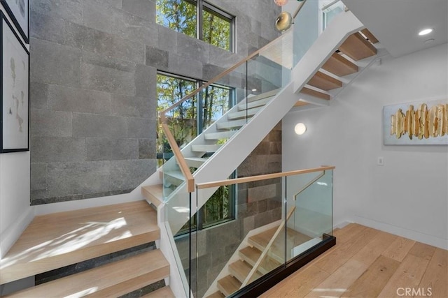 stairway with hardwood / wood-style floors