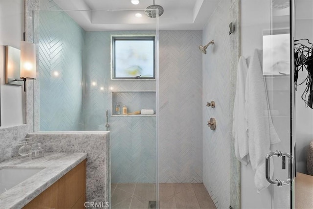 bathroom with vanity and a shower with shower door