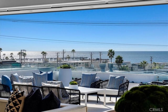 view of patio featuring a balcony and a water view