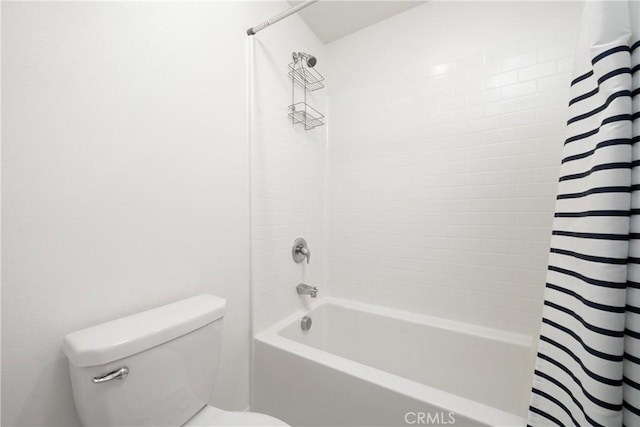 bathroom with shower / bathtub combination with curtain and toilet