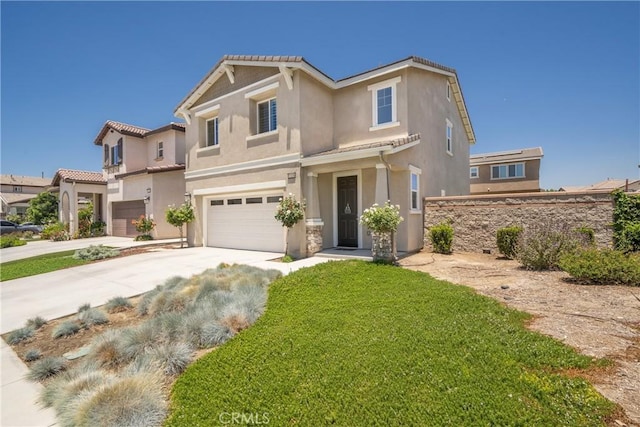 mediterranean / spanish-style house featuring a garage and a front yard