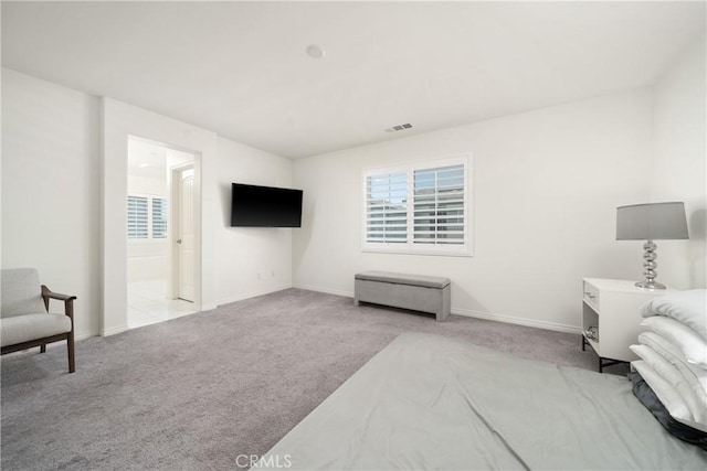 interior space with light colored carpet and connected bathroom