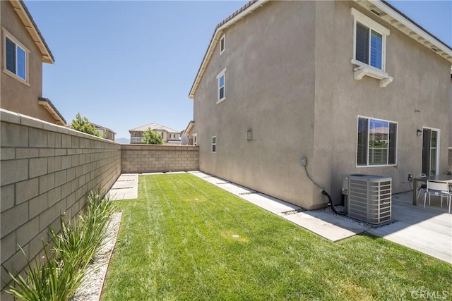 view of yard featuring central AC and a patio