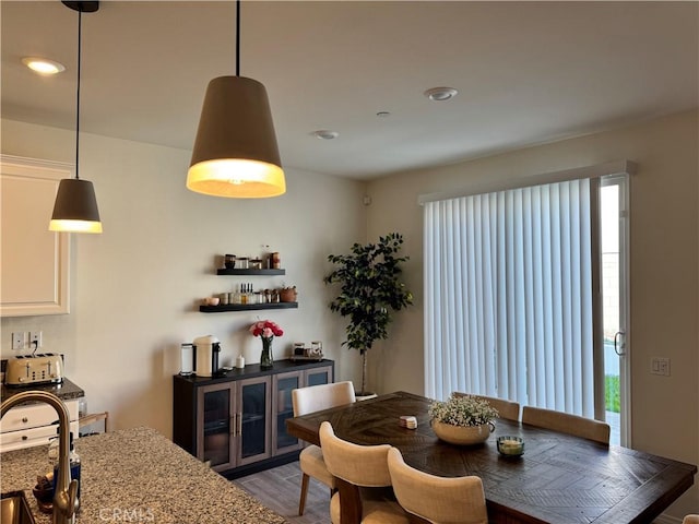 dining area featuring sink and hardwood / wood-style flooring