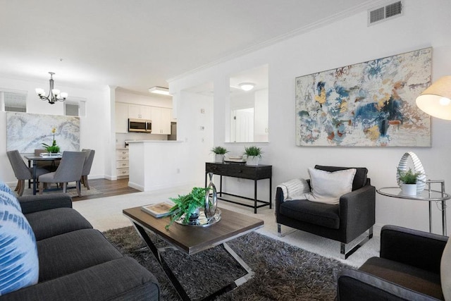 living room featuring ornamental molding and a chandelier