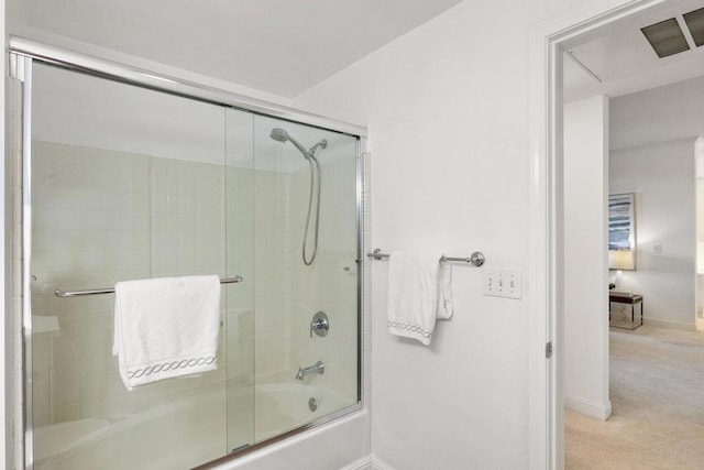 bathroom with combined bath / shower with glass door