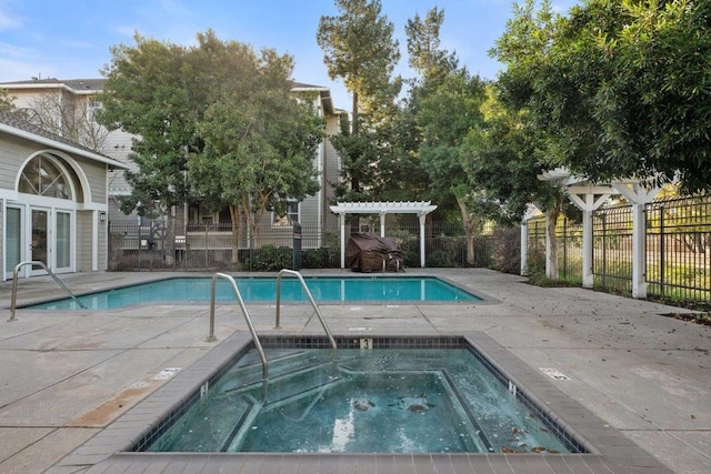 view of swimming pool with a community hot tub and a pergola