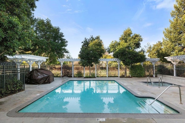 view of swimming pool with a grill and a pergola