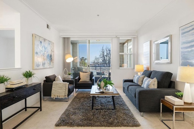 carpeted living room with crown molding