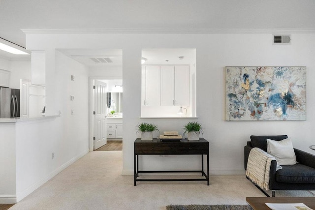 interior space featuring crown molding and light colored carpet