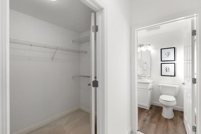 bathroom with vanity, hardwood / wood-style floors, and toilet