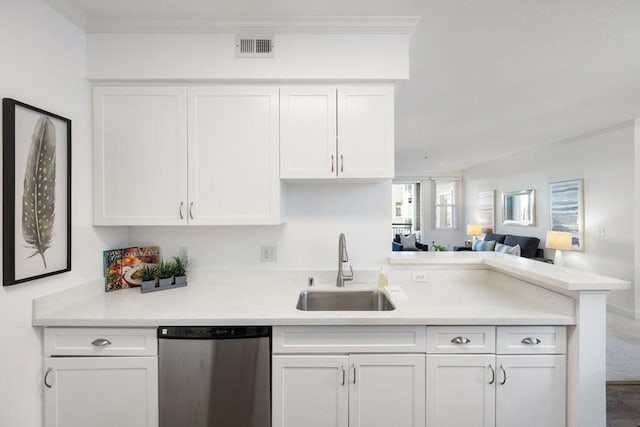 kitchen featuring sink, white cabinetry, crown molding, stainless steel dishwasher, and kitchen peninsula