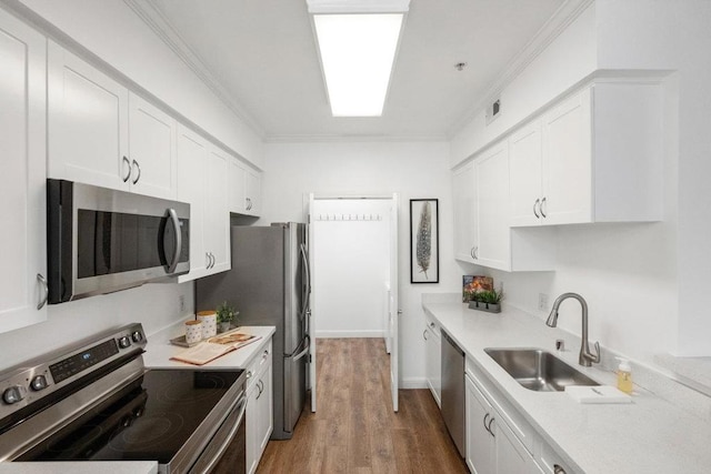 kitchen featuring appliances with stainless steel finishes, sink, and white cabinets