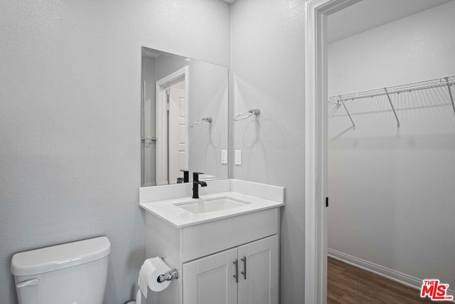 bathroom featuring vanity, toilet, and wood-type flooring