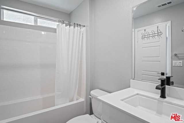 full bathroom featuring vanity, toilet, and shower / bath combo with shower curtain