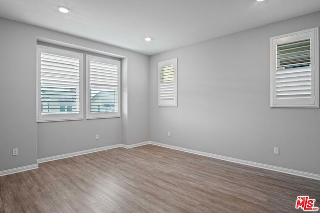 unfurnished room with wood-type flooring