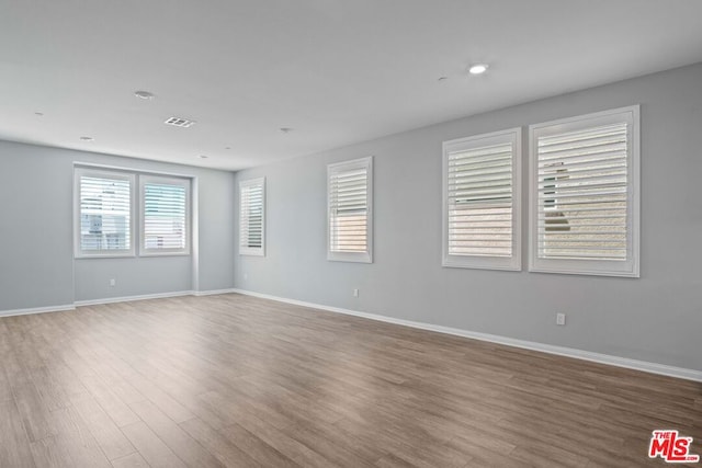 spare room with hardwood / wood-style floors