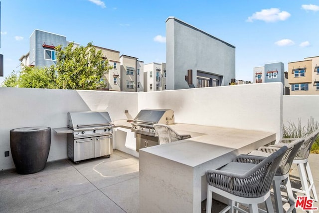 view of patio featuring a bar and area for grilling