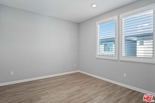 empty room with hardwood / wood-style flooring