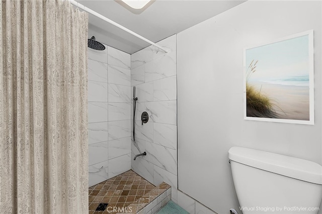 bathroom featuring curtained shower and toilet