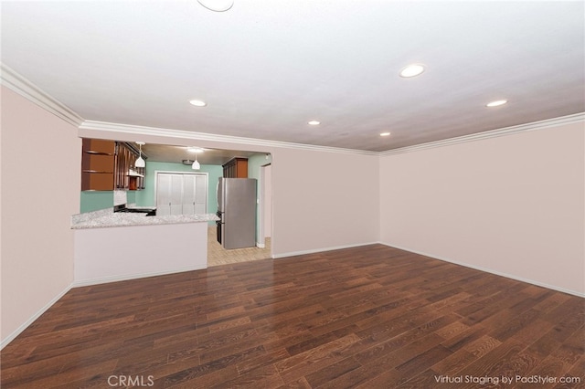 unfurnished living room featuring dark wood-type flooring and crown molding