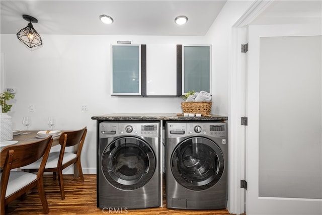 laundry area featuring visible vents, wood finished floors, laundry area, independent washer and dryer, and baseboards