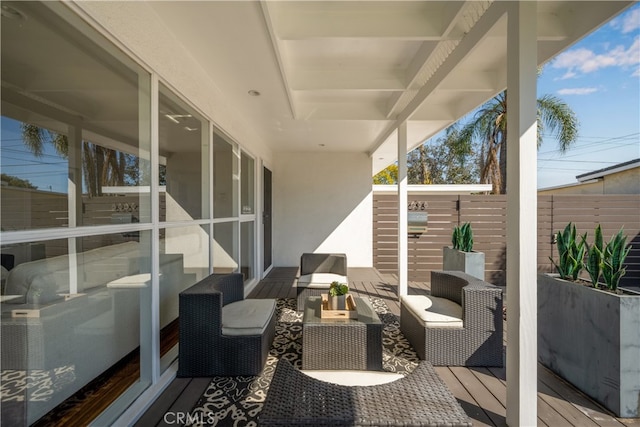 wooden deck featuring fence and an outdoor living space