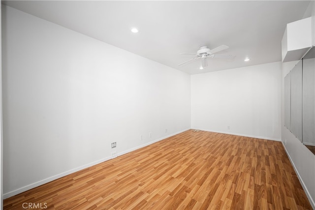 unfurnished room with light wood finished floors, recessed lighting, a ceiling fan, and baseboards