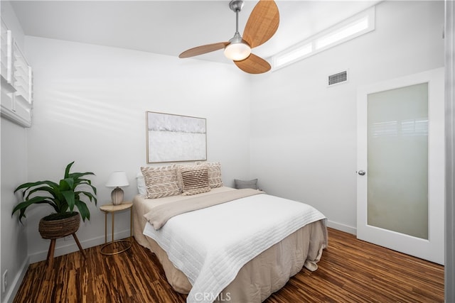 bedroom with ceiling fan, baseboards, visible vents, and dark wood finished floors