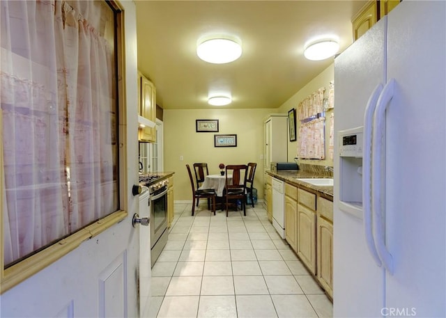 kitchen with white appliances, extractor fan, light brown cabinetry, a sink, and light tile patterned flooring