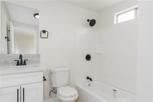 full bathroom featuring tiled shower / bath, vanity, toilet, and backsplash