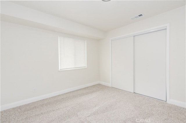 unfurnished bedroom with a closet and carpet