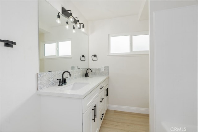 bathroom featuring vanity, plenty of natural light, and wood-type flooring