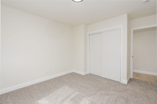 unfurnished bedroom with carpet floors and a closet