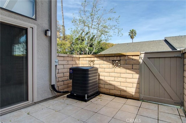 8566 Larkhall Cir Unit 809D, Huntington Beach, CA 92646 - view of patio featuring central AC unit and fence