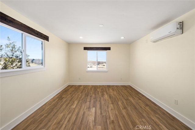 empty room with dark hardwood / wood-style flooring and a wall mounted AC