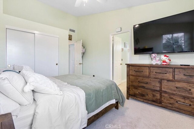 carpeted bedroom featuring lofted ceiling, a closet, and ceiling fan