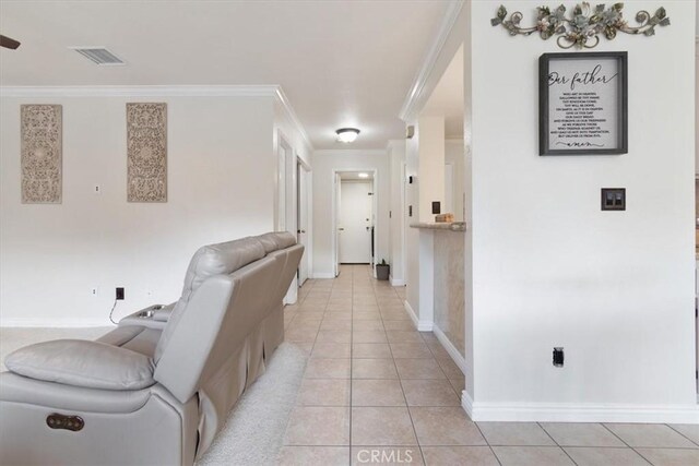 hallway with crown molding and light tile patterned flooring