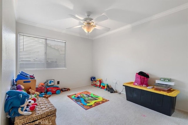 recreation room featuring ornamental molding, carpet flooring, and ceiling fan