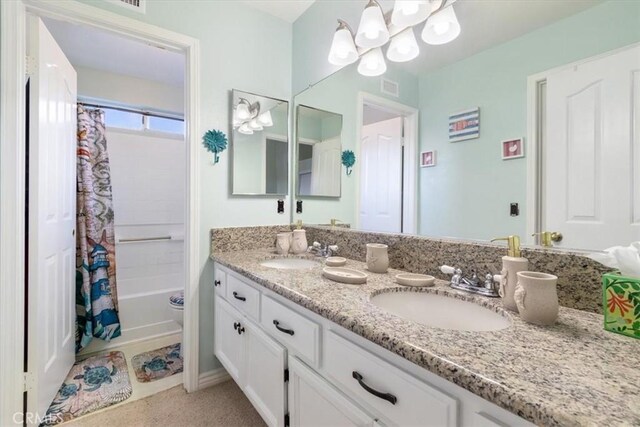 bathroom with vanity and shower / bath combo with shower curtain