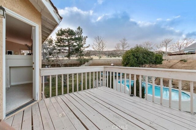 wooden deck featuring a fenced in pool