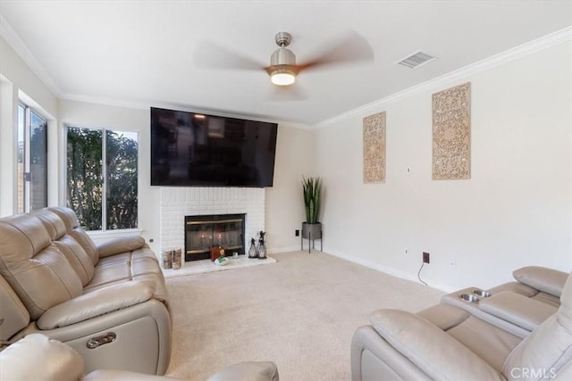 carpeted living room featuring a fireplace, ornamental molding, and ceiling fan